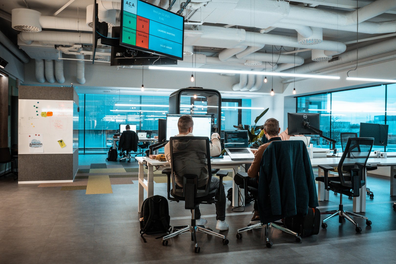 Colleagues pair programming in open space