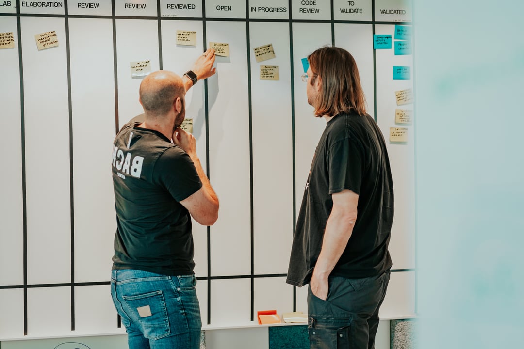 Product team collaborating in office on digital product strategy and user-focused solutions Product team collaborating in office on digital product strategy and user-focused solutions