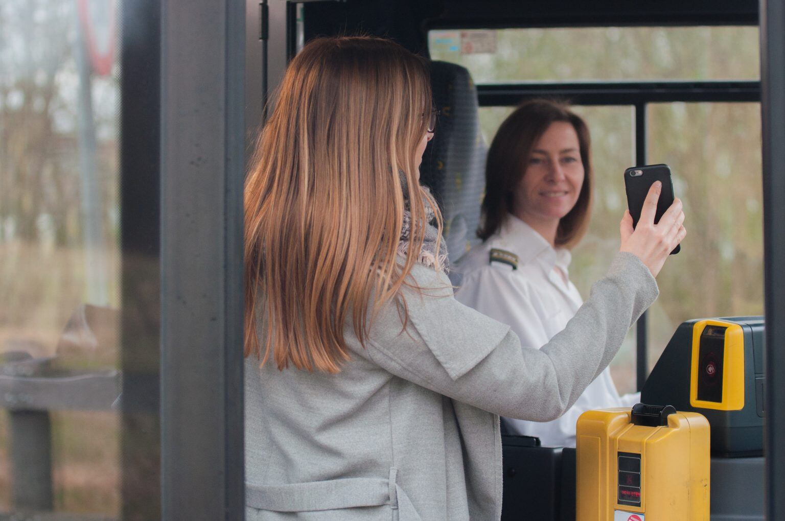 woman getting on bus