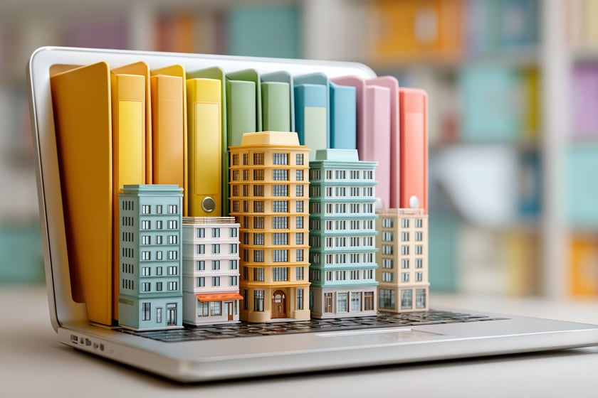 A laptop with folders and 3D buildings A laptop with folders and 3D buildings