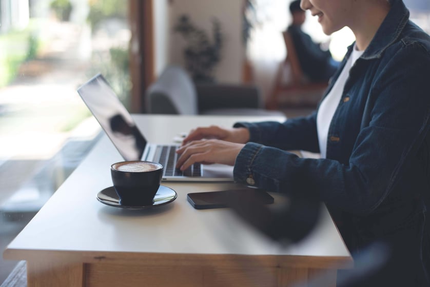 person typing on laptop with coffee - liantis case person typing on laptop with coffee - liantis case