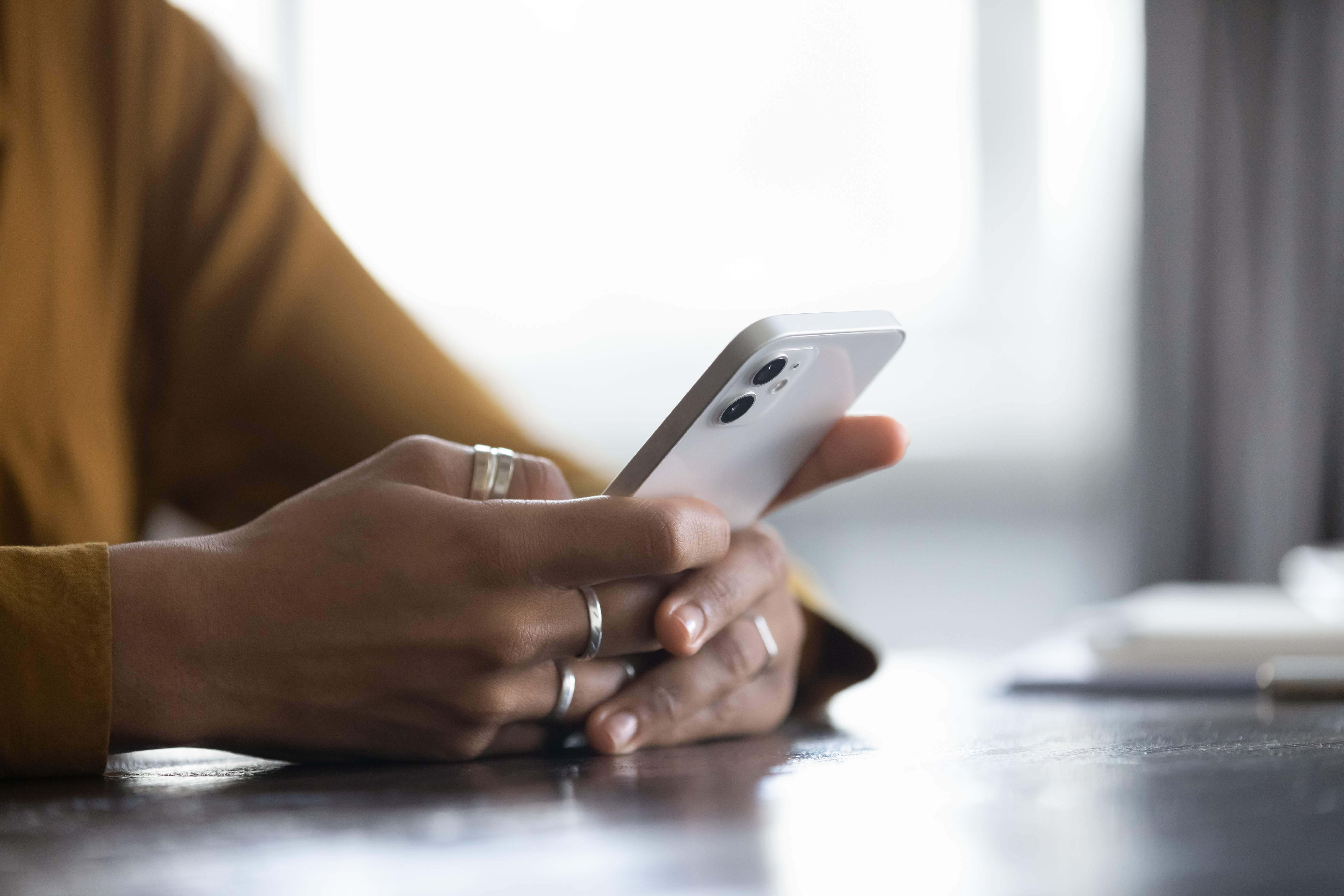 persoon die zijn mobiele telefoon gebruikt