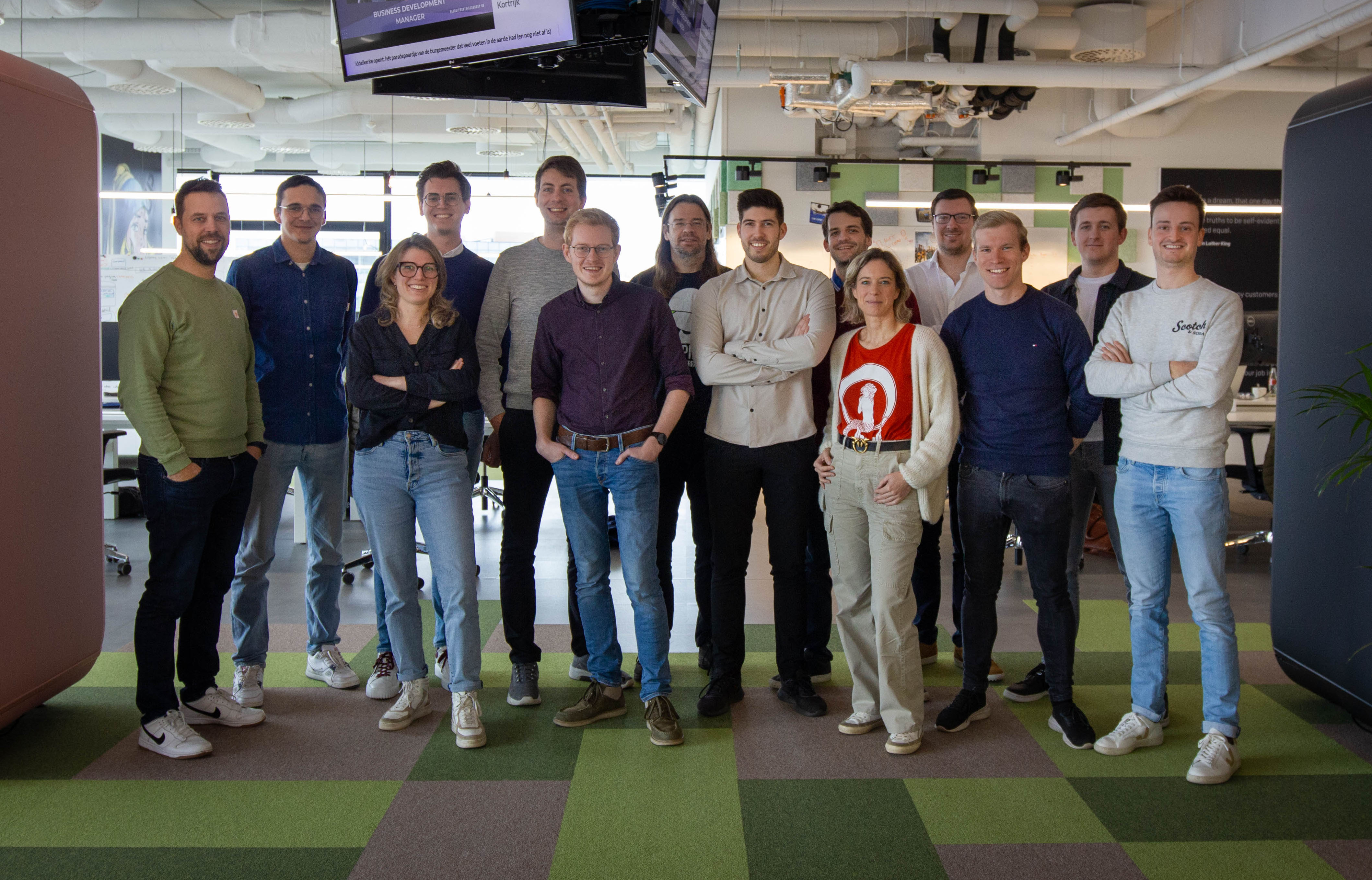 A group of people standing for a photo in the office